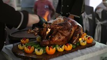 A Chef Cuts A Cooked Turkey At A Feast In Front Of People. Chefs Show.