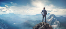 A Male Executive Perched On A Rocky Cliff, Gazing Out At The Expansive View Below, Signifying A Leader's Ability To See The Bigger Picture In The Business World.