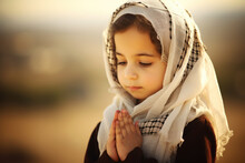 Cute Little Muslim Girl Praying On The Nature Background. 