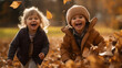 Happy children playing outside with leaves in park during autumn fall season