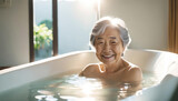 Fototapeta  - Elderly asian lady enjoying a hot bath with copy space