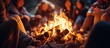 © The 2R Artificiality - Hand of woman warming on campfire Asian friends sitting around campfire at night Friends camping near bonfire on winter vacation at night With copyspace for text
