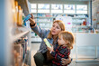 © Marko Geber - Young woman shopping for supplies with her daughter at the pharmacy