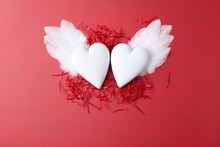 Two White Hearts With Wings On A Red Background