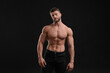 © New Africa - Handsome muscular man on black background. Sexy body