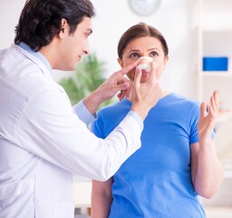 Wall Mural - Woman visiting male doctor for plastic surgery