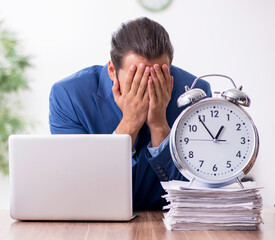 Wall Mural - Young male businessman working in the office