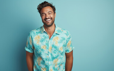 Wall Mural - happy handsome fashion man smiling and wearing colorful flower pattern shirt, solid light color background