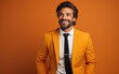 © hakule - happy handsome fashion businessman smiling and wearing color suit, solid light color background