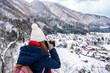 Young woman traveler enjoying with snow at shirakawa-go in winter, Travel concept