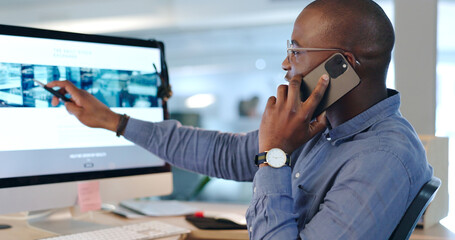 Businessman, phone call and pointing at computer in office while talk, consult or listen. Black person, analyst or developer for customer service with communication, feedback or support on website