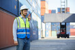 © offsuperphoto - factory worker or engineer using walkie talkie and talking about work in containers warehouse storage