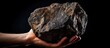 Miner holding a rough nugget of iron ore focusing on hematite stone With copyspace for text