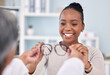 © D Theron/peopleimages.com - Black woman, patient and doctor with glasses, eye care and vision consultation with optometrist, appointment and choice. Prescription lens, frame and help with smile, advice and optometry healthcare