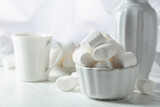 Fototapeta Dinusie - White marshmallows on a wooden table.