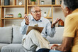 © aLListar/peopleimages.com - Senior man speaking to a psychologist at mental health, psychology and therapy clinic for session. Psychological therapist with clipboard for counseling checklist with elderly male patient in office.