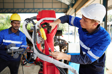 Wall Mural - factory workers or engineer checking and fixing machine in robot factory