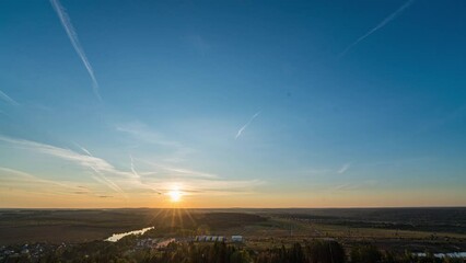 Wall Mural - Sunset timelapse above the valley, view from the mountain. Blue sky with moving clouds. Beautiful landscape, 4k