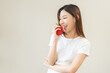 © KMPZZZ - Healthy diet food with capsicum, portrait smile of asian young woman holding, eating red bell pepper isolated on background, fresh vegetable from nature organic for wellness, happy nutrition lifestyle