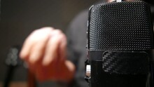 Person Recording A Podcast. Podcast Studio: Close-up Shot Of A Microphone In A Recording Studio. Person Speaking On A Podcast. Person Speaking Into Microphone. Podcasting. Podcast Episode. Podcast Day