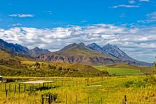 Description
Landscape Of Green Fenced Fields And Farmland With Jagged Langeberg Mountains In The Background Near Nuy In The Western Cape, South Africa