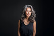 © uv_group - Portrait of asian lady, senior woman with grey hair smiling and looking at camera, standing over grey background.