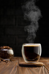 Wall Mural - espresso in glass cup on table with black background