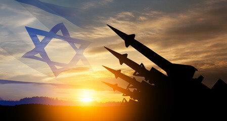 Wall Mural - The missiles are aimed at the sky at sunset with Israel flag. Nuclear bomb, chemical weapons, missile defense, a system of salvo fire.