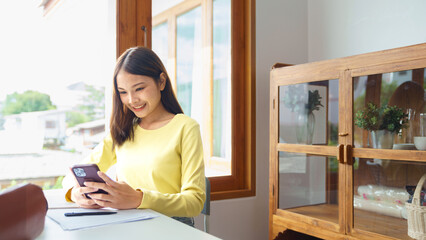 Wall Mural - Education and literacy concept, College student girl using smartphone during take a break class