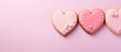 Valentine s card showcasing heart shaped cookies in three colors on a pastel pink background