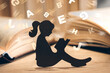girl with dyslexia holds a book. Flying tangled letters in the air. The child learns to speak and read correctly