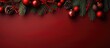 Christmas themed still life arrangement with red ornaments and fir tree branches on a red backdrop Overhead shot with blank area for text
