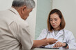 © surachetkhamsuk - Asian Female Doctor examining old male patient in hospital