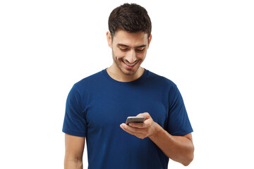Wall Mural - Young man standing in blue t-shirt, looking at phone, surfing web and smiling while browsing content
