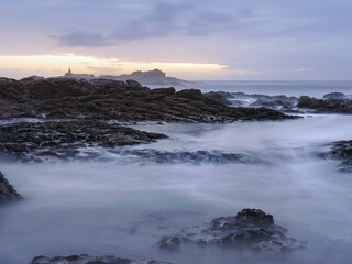 Sticker - Rocky sea beach at dusk