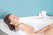 © Svetlana Radayeva - Young woman relaxing in bathtub with foam