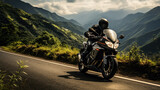 Fototapeta  - Motorcyclist navigates winding mountain roads soaking in the scenic beauty 