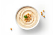 Hummus in bowl on white background, top view