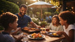 © visoot - Family enjoying barbecue sandwiches at outdoor dining setup.