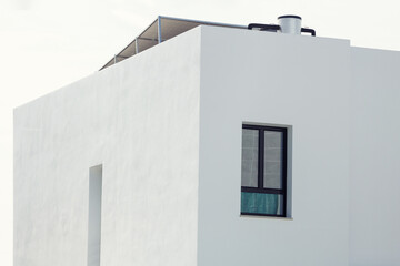 Poster - Sustainable housing. Facade of a house with solar panels on the roof.