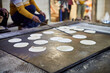 Making of chapati round flatbreads for langar in sikh gurudwara temple many uncooked roti flatbreads