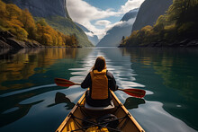 View From The Back Of A Girl In A Canoe Floating On The Water Among The Fjords.