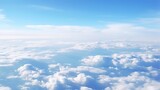 Fototapeta  - Panoramic view of fields and clouds from an airplane window. The sky is a bright blue with fluffy white clouds.