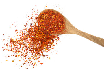 Wall Mural - Spicy chili red pepper flakes, chopped, milled dry paprika pile in wooden spoon isolated on white, top view
