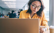 © BullRun - Woman browsing smartphone in workspace