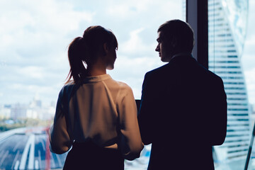 Wall Mural - Entrepreneurs standing near window at workplace