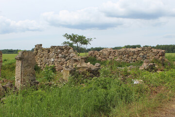 Abandoned stone farmhouse with only the walls remaining in Sece, Latvia