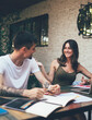 © BullRun - Young happy people studying together in terrace