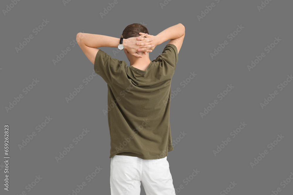 Man in stylish t-shirt on grey background, back view
