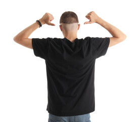 Wall Mural - Man pointing at his stylish t-shirt on white background, back view